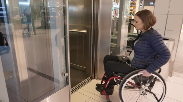Disabled woman waiting for elevator in a store