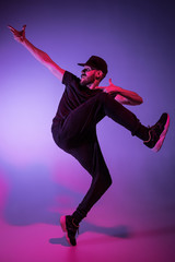 Fototapeta na wymiar The silhouette of one hip hop male break dancer dancing on colorful background