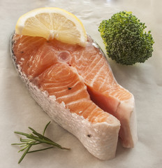 salmon raw. salmon red fish steak with herbs and lemon isolated on a white background