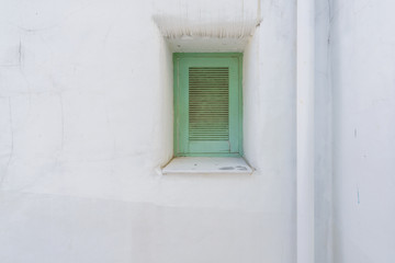 Fototapeta na wymiar Blue window on Mallorca mediterranean white wall