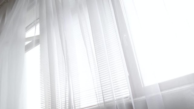 Moving white curtains on a draft in spring time