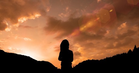 Silhouette girl standing on mountain against sky during sunset