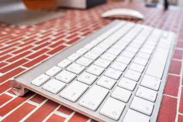 working in office / top view of an office place with modern technology on red brick background
