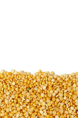 Dry yellow split peas isolated on white.