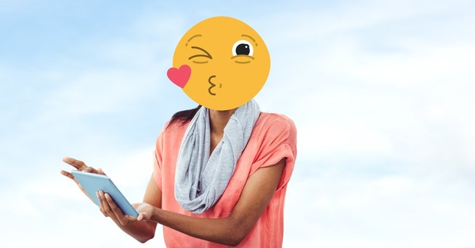 Woman with emoji over face using tablet PC - Powered by Adobe