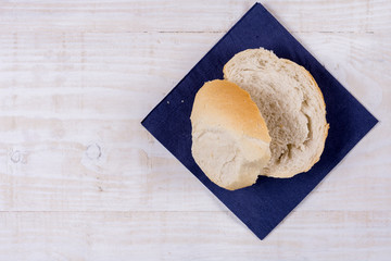 Sliced bread on the blue napkin over wooden background
