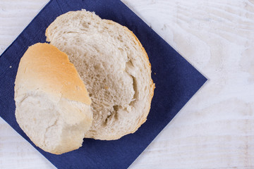 Sliced bread on the blue napkin over wooden background