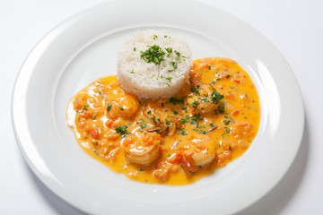 souse shrimp with greens and rice on a white background