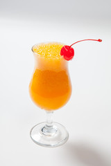 orange cocktail decorated with cherry on white background