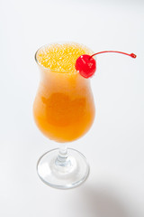 orange cocktail decorated with cherry on white background