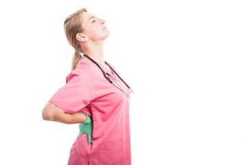 Female medical nurse holding her back like hurting