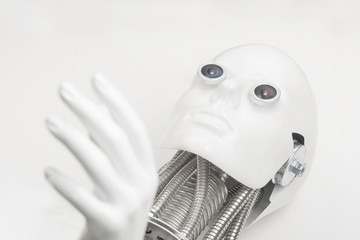 Humanoid robot head with hand closeup. Robot lying down