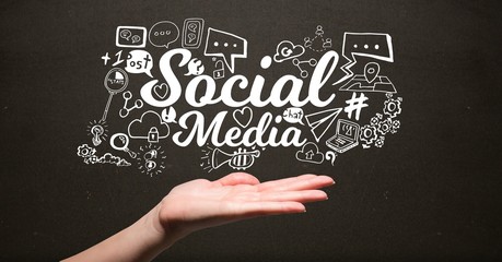 Digital composite image of hand under social media graphics