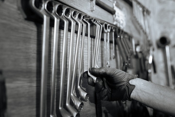 Qualified able specialist choosing a wrench