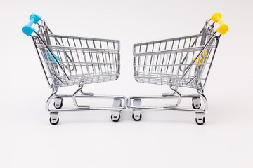 Two shopping trolley on the white desk