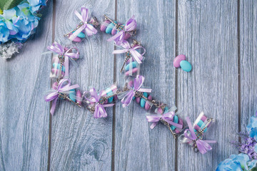 Wedding favors. Boxes with purple and white ribbon containing violet and blue confetti and key gift.