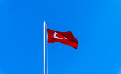 turkish flag waving in blue sky
