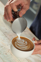 Barista making coffee with latte art