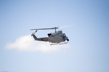 Helicopter bell uh 1 approach landing, back right tail side view machine gun