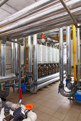 Interior of industrial, gas boiler house with a lot of boilers and equipment