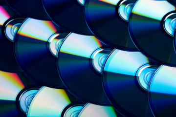 Compact discs background. Several cd dvd blu-ray discs. Optical recordable or rewritable digital...