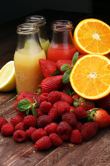 several bottles with fruit and berry juices smoothies and milksh