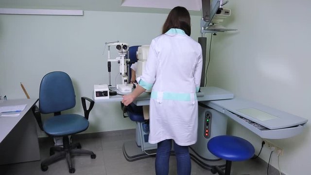 doctor diagnoses the patient's vision using ophthalmic refractometer