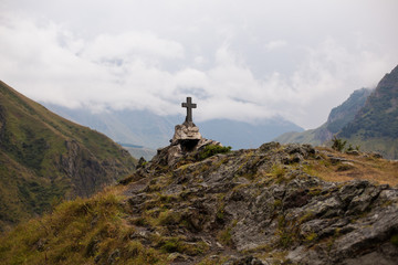 GEORGIA, KAZBEGI Orthodox cross near Caucasus mountains.