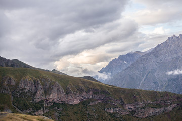 Fototapeta premium ountain panoramic view on a evening. Beautiful evening mountain landscape under bright sunset. Georgia Kazbegi