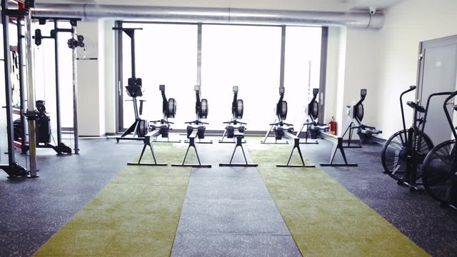 Rowing machines in a row in modern gym