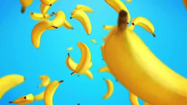 CGI animation of yellow ripe bananas floating against blue background 