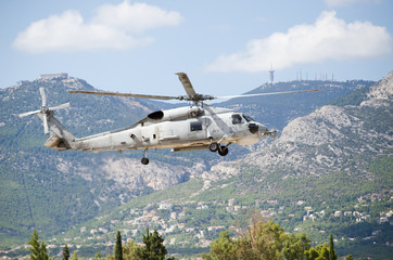 Black hawk helicopter rescue team.Approach landing, exhaust gas, Aviation antennas on mountain background © John Vlahidis
