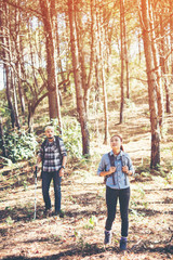 Fototapeta premium Young couple hiking at the pine forest.