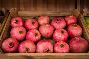 Pomegranates in a box. Pomegranate background.