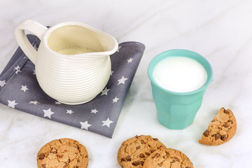Chocolate chips cookies with milk glass and jar