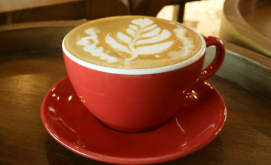 Coffee late art style on wooden table.