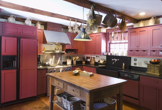 Kitchen in colonial house with red cabinets