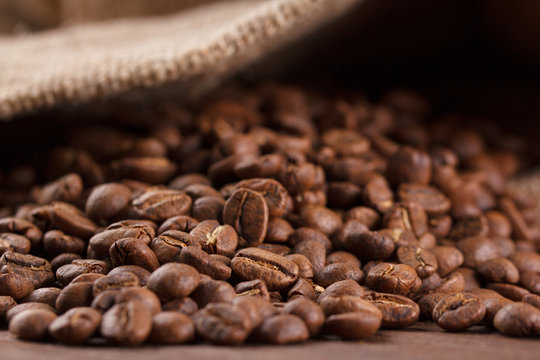 coffee beans roasted on wood background, macro