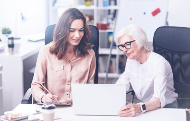 Kind brunette looking at computer