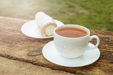 cup of tea with lemon on wooden background