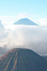 Mount Bromo, an active volcano surrounded by white clouds of mist in the morning at the Tengger Semeru National Park in East Java, Indonesia.