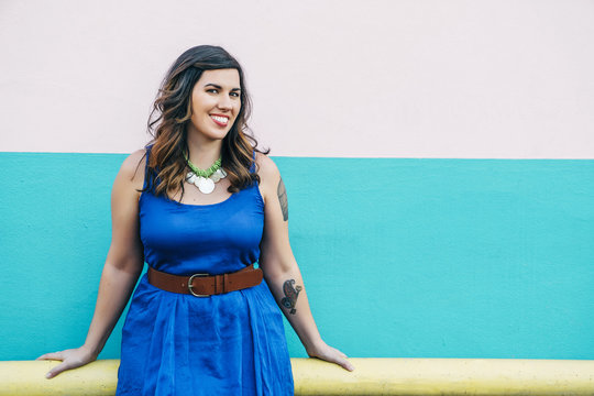 Portrait of smiling Mixed Race woman wearing blue dress