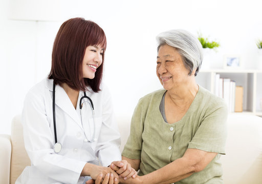  young smiling home caregiver  with senior woman
