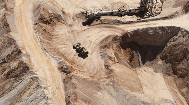 USA, Texas, aerial view of sand mine near San Antonio with a grader moving sand
