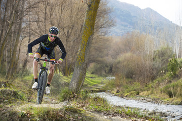 Obraz premium Cyclist man riding mountain bike on mountain.