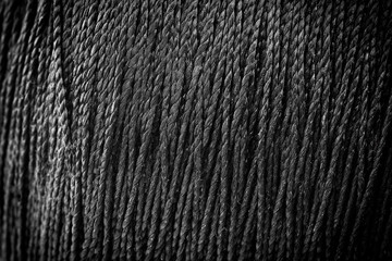 reel black synthetic thread. textile concept. abstract background