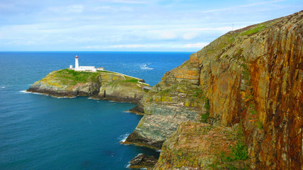 Fototapeta na wymiar The South Stack Lighthouse - built on the summit of a small island off the north-west coast of Holy Island, Anglesey, Wales. Historically built in 1809 to warn ships of the dangerous rocks below.