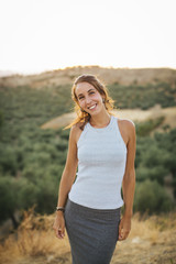 Smiling happy woman at sunset.