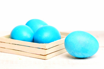 traditional easter eggs painted in blue color in wooden box