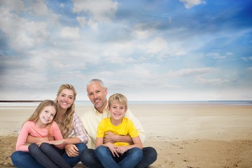 Fototapeta na wymiar Portrait of happy family at beach against sky